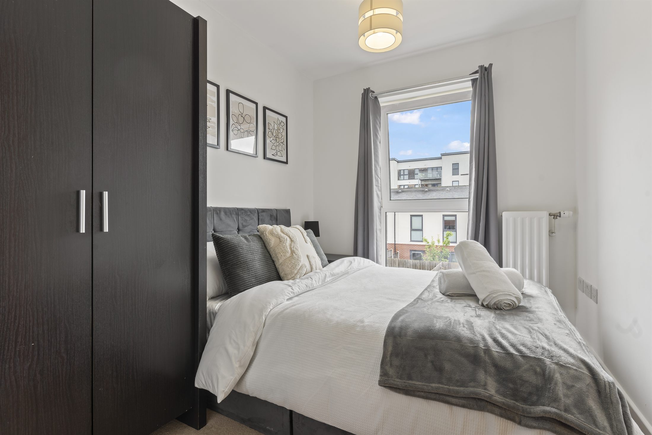 A made-up double bedroom with fresh linen at a Jathan Properties home